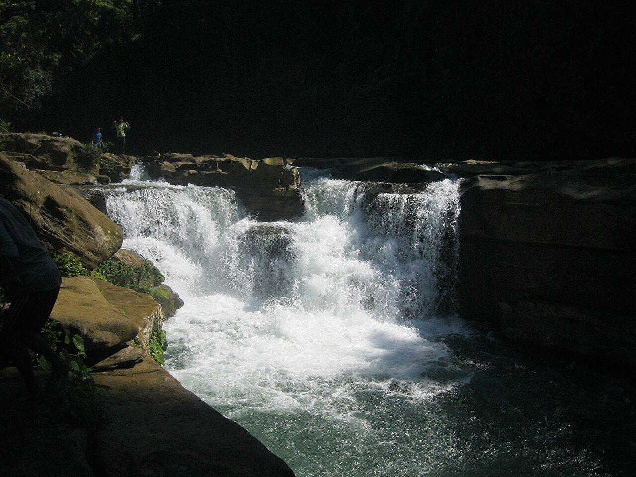 Nafakhum waterfall pouring over a wide rock ledge in Bandarban